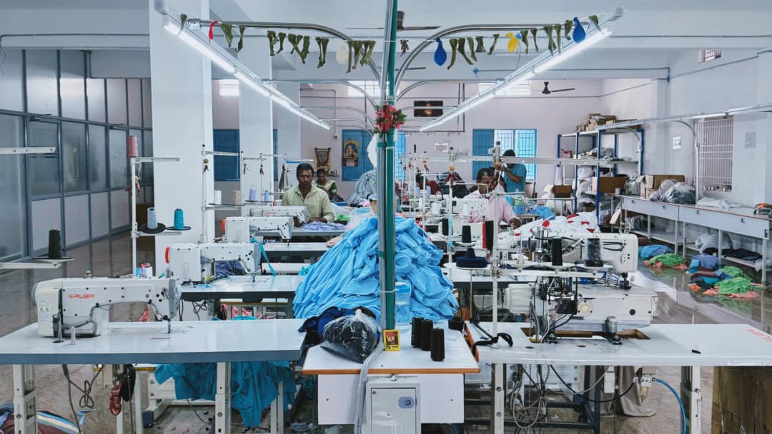 Garment workers at sewing machines on the production floor